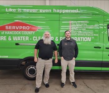 male General Manager Picture in front of green van